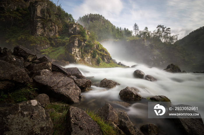 Fjord waterfall long exposure. Silky water. Moving water. Waterfall in motion.