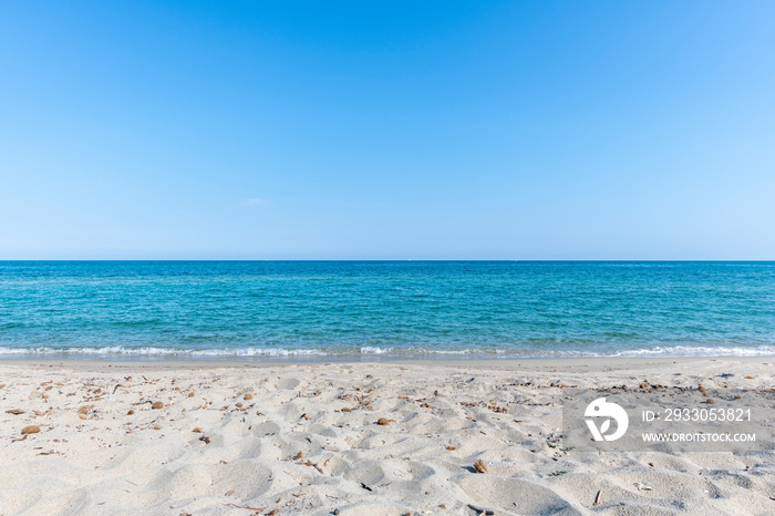 Sandy Beach and mediterranean sea during summer with large copy space, Ghisonaccia, Corsica, France. Horizon over water