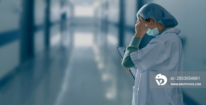 female doctor holding a syringe in hospital.