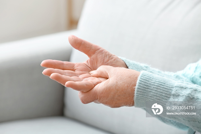 Hands of elderly woman at home