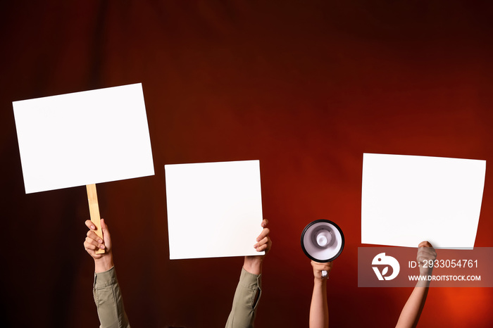 Protesting people with megaphone and placards on dark background