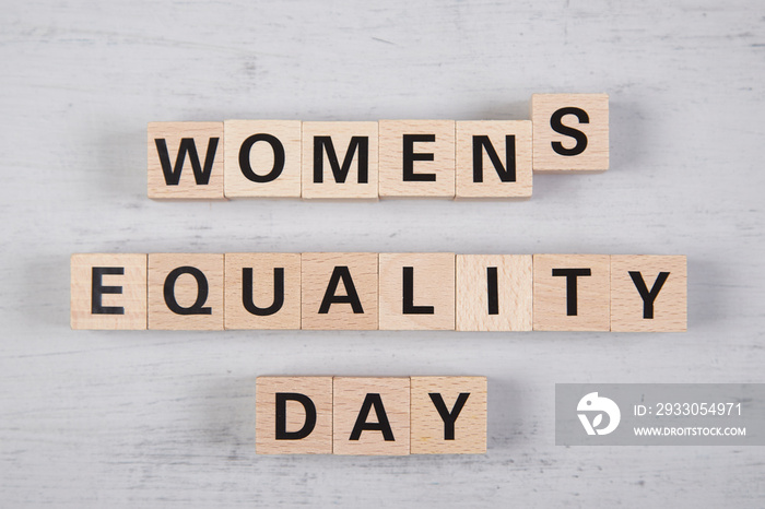 wooden blocks building the word womens equality day