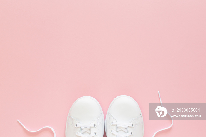 All white sneakers on pink background. Top view,flat lay