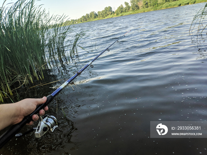 fishing rod in hand. fishing on the river