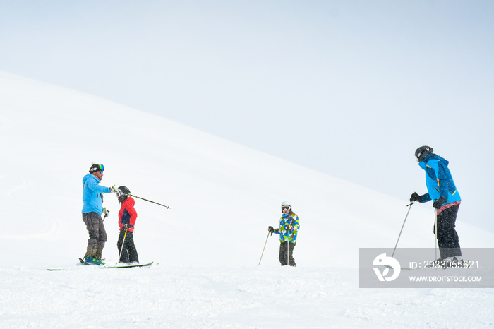 Ski instructor teach beginner skiers on slope in winter resort