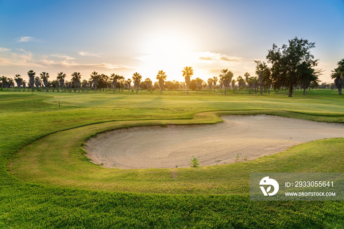 Beautiful, with green grass, golf course, with sand, with blue and clear sky. Portugal, Algarve.