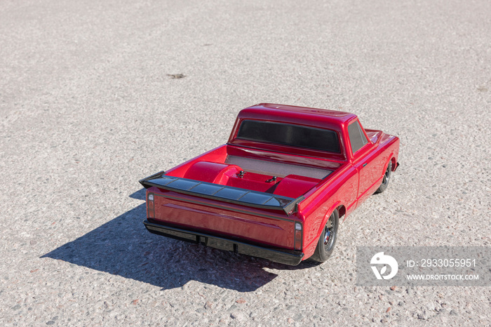 Close up back view  of radio-controlled vintage car model isolated on asphalt. Sweden.