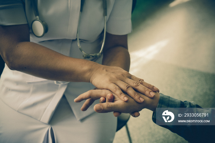 Nurse holding the hand of a patient man, showing sympathy and kindness, vintage style