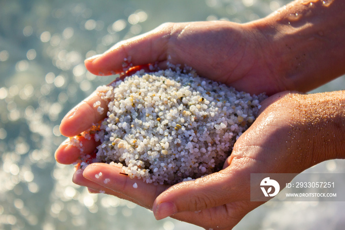 Quartz sand in the female hands