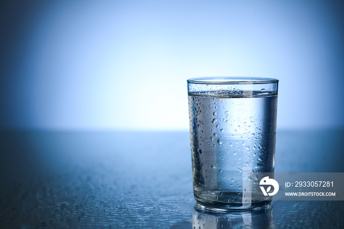 Glass of fresh cool water on table