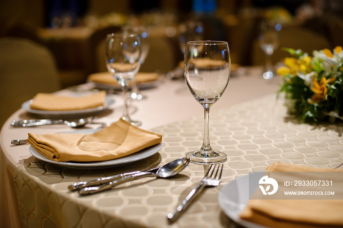 glass wine on table.restaurant glass of water on table / dish and spoon