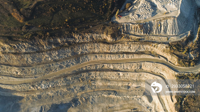 Panoramic view of quarry. Shot. Top view of picturesque quarry located on coastal mountain near village in forest. Concept of mining