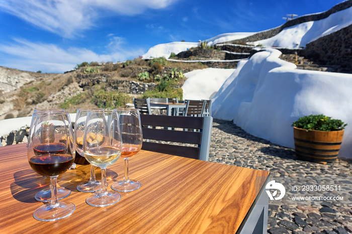 Glasses of wine in a terrace, Santorini, Greece.