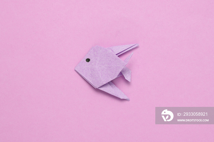 Origami fish on a pink background