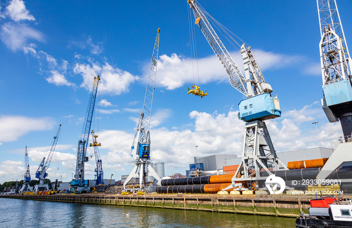 Cranes at port of Rotterdam, Netherlands. Logistics business, cargo loading unloading