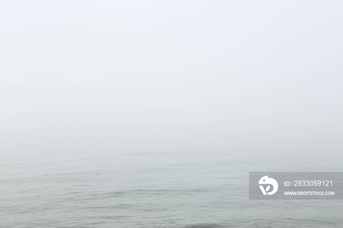 Seascape in fog. Abstract background in the form of a blue sea in the fog. Free space for text.