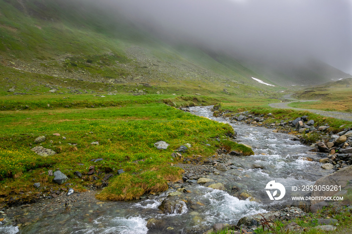 alpin river and misty mountains (Vorarlberg, Austria)