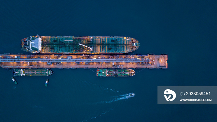 Aerial view oil ship tanker at terminal sea port, Large crude oil tanker unloading at port, Business import export oil and gas petrochemical with tanker ship transportation oil from dock refinery.