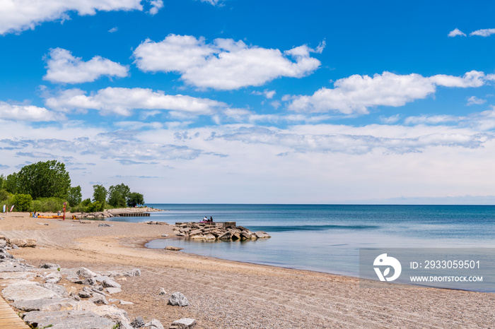 Beach at midday in June with few users and big sky.  Shot in the Toronto Beaches