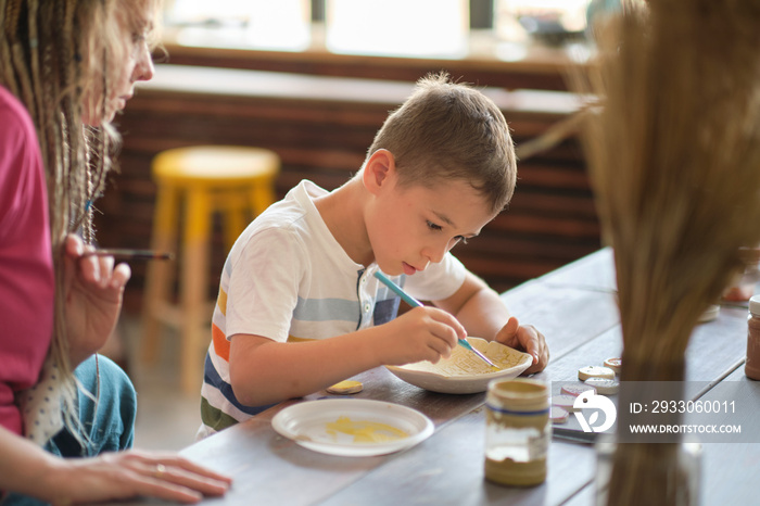 workshop for kids. Children learning how to use clay for making beautiful dishes. Workshop, master class.