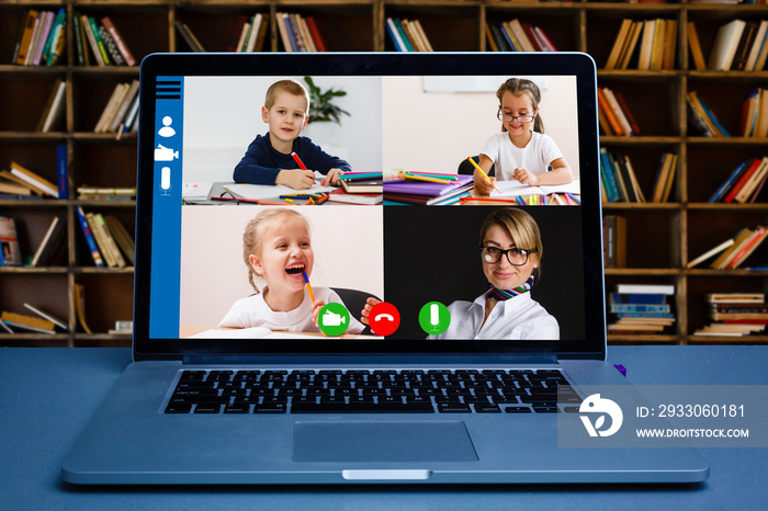 Boy video conferencing with tutor on laptop at home. Distance education concept.