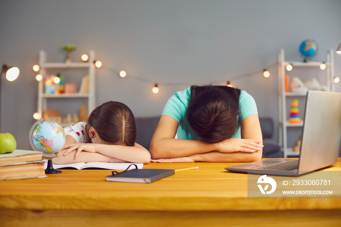 Little girl with her mother lying on table near laptop computer, exhausted from online home schooling