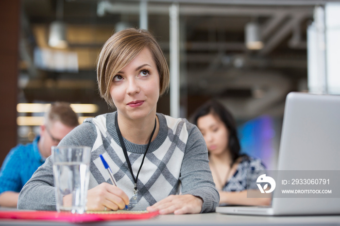 Pretty businesswoman paying attention in classroom.