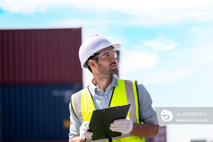 Logistics engineer working with checking list of shipping container in commercial transport port