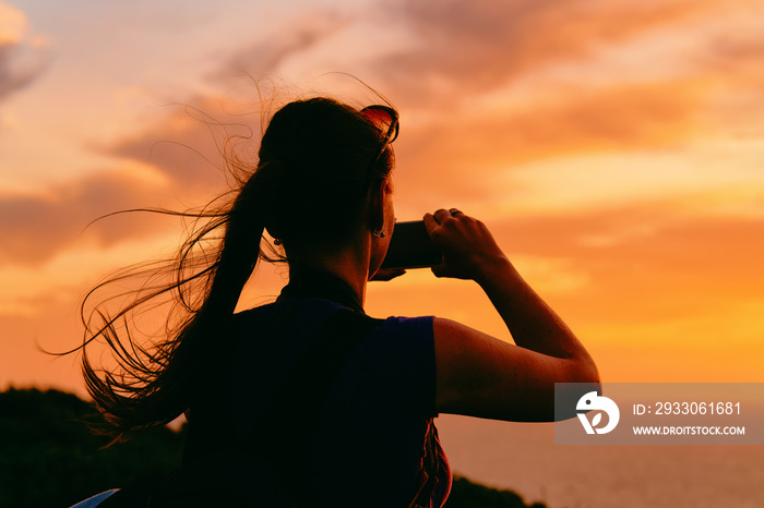 Sunrise or sunset and young girl and Capo Ferro in Costa Smeralda