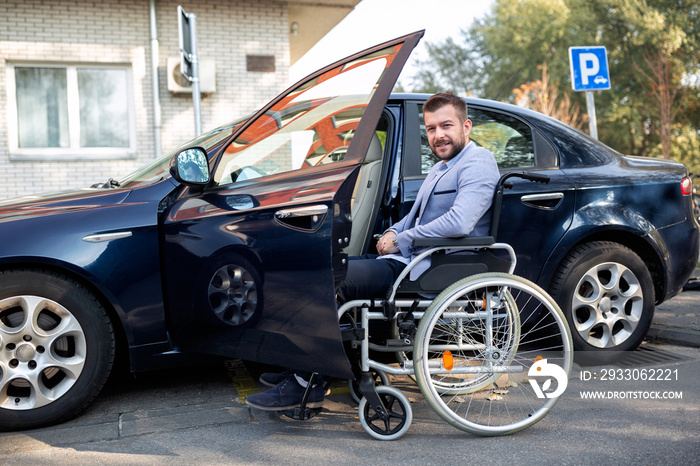 Handicapped young man reaching for his car