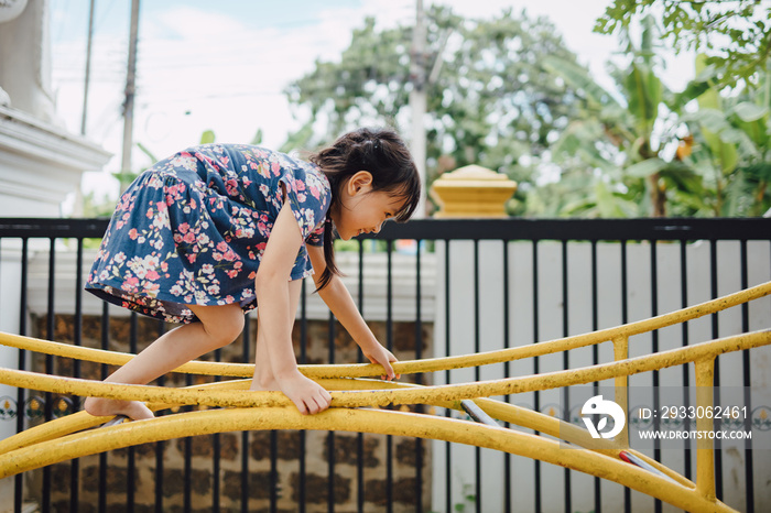 Kids having fun by climbing up ladders at the playground in the park. Education and developmental activity for preschool children concept.