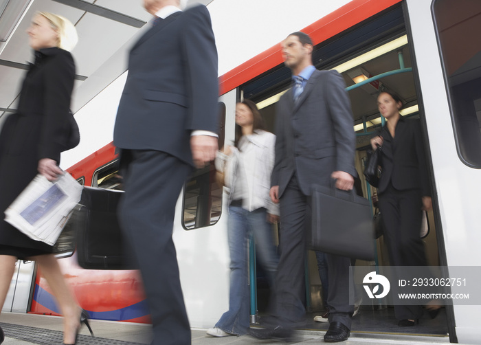 Low angle view of business commuters getting off a train