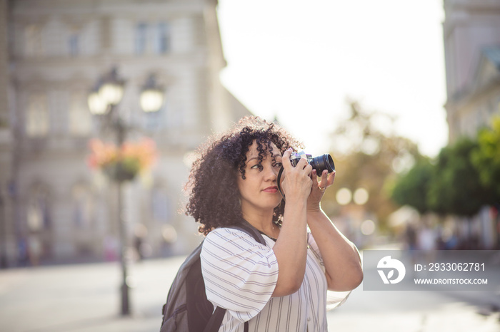 Mixed race woman taking photo.