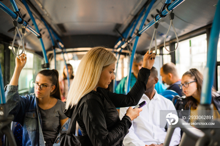 Woman with phone at the public transport