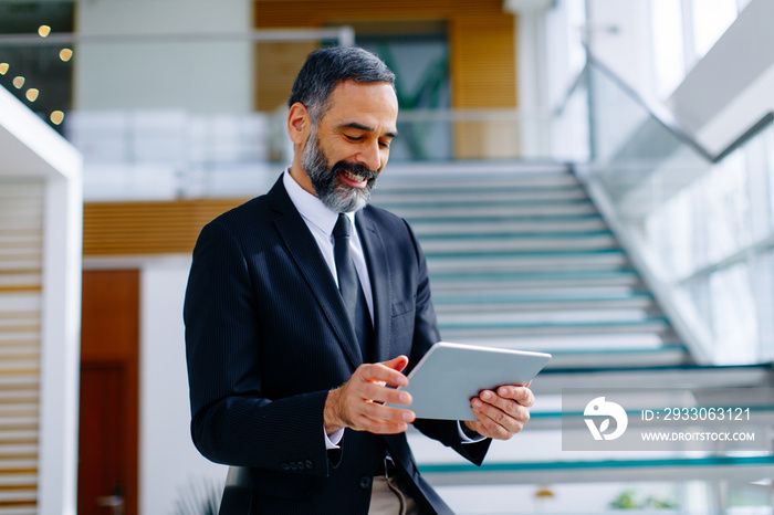 Middle age businessman with tablet in the office