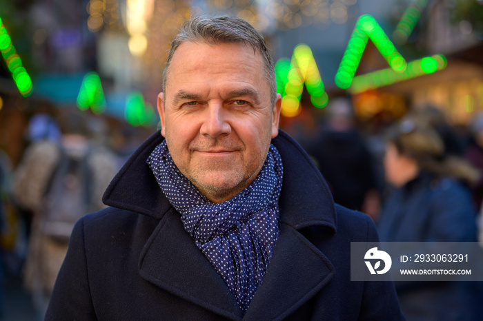 Attractive fashionable man in coat and scarf