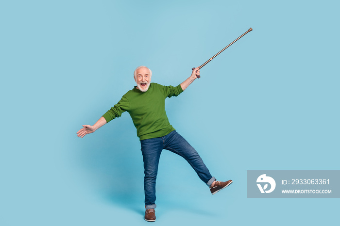 Full size portrait of overjoyed satisfied funny granddad hold stick have good mood isolated on blue color background