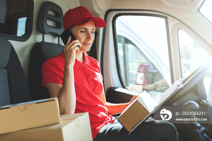 delivery woman talking on mobile phone in van