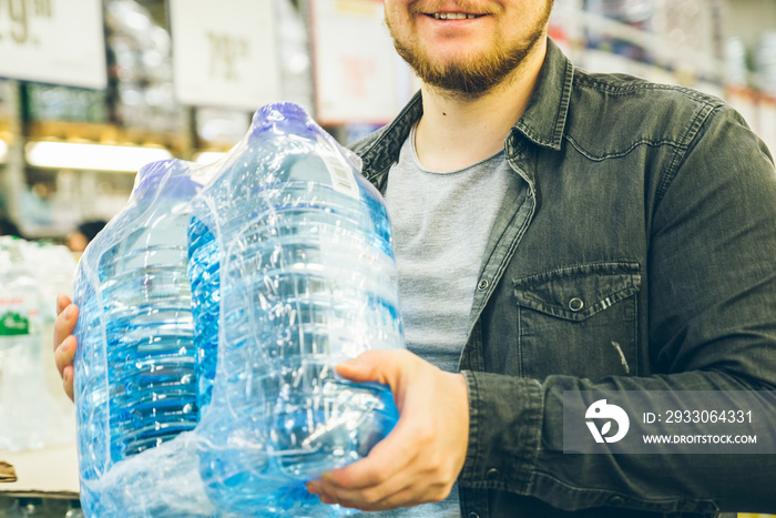 man take water from the shelf of the store