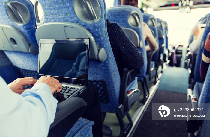 man with smartphone and laptop in travel bus