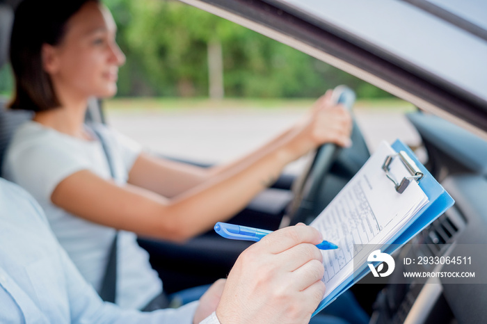 Instructor and young female student, driving lesson