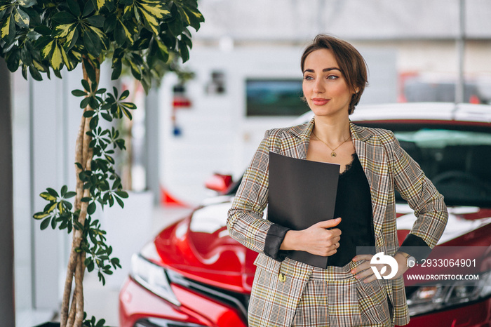 Car saleswoman in a car showroom