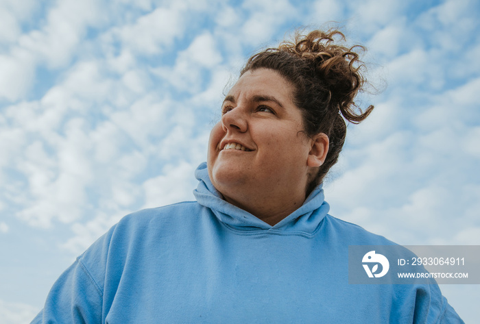 closeup plus size woman smiling against sky