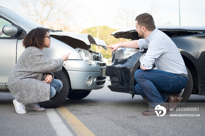 Man and woman arguing after a car crash