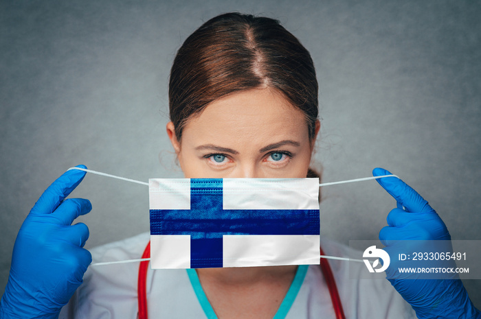 Coronavirus in Finland, Female Doctor Portrait hold protect Face surgical medical mask with Finland National Flag. Illness, Virus Covid-19 n Finland, concept photo