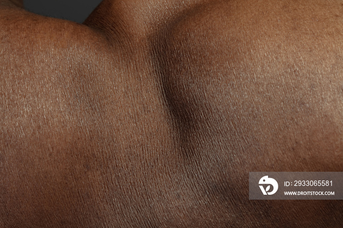 Detailed texture of human skin. Close up shot of young african-american male body. Skincare, bodycare, healthcare, hygiene and medicine concept. Looks beauty and well-kept. Dermatology.