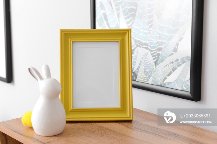 Ceramic rabbit with frame on wooden table