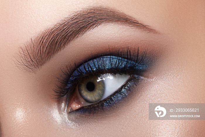 Closeup Macro of Woman Face with Blue Eyes Make-up. Fashion Celebrate Makeup, Glowy Clean Skin, perfect Shapes of Brows