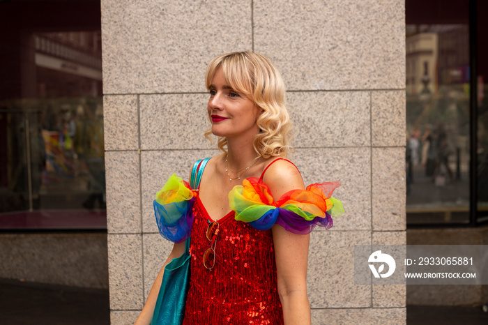 Mid adult woman wearing rainbow-flag themed decorations