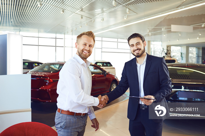 A man buy a new car. A man and a car salesman make a handshake